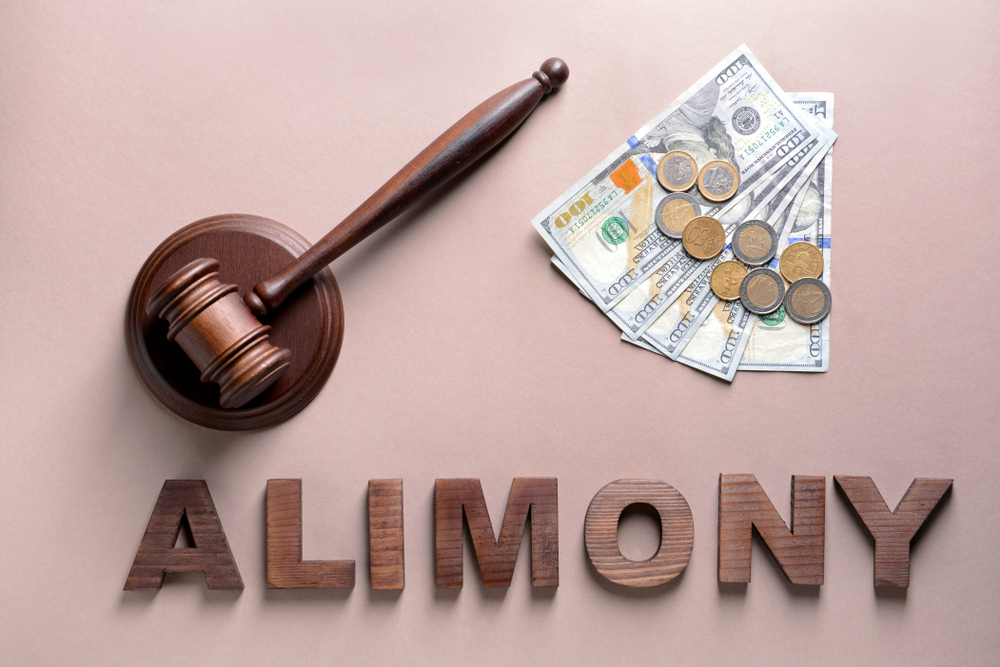 money on the table with alimony word