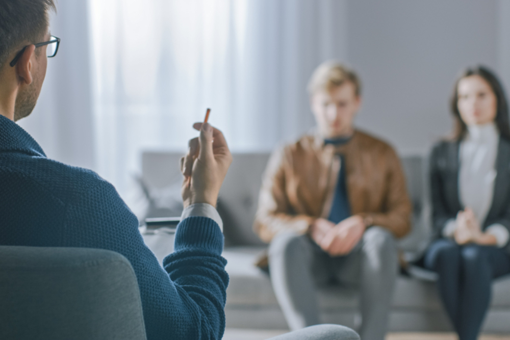 unfocused couple on counseling session with psychotherapist