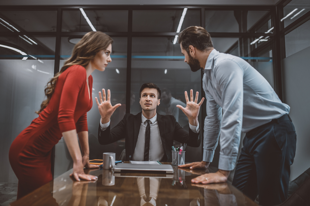 a lawyer trying to stop the argument between spouses