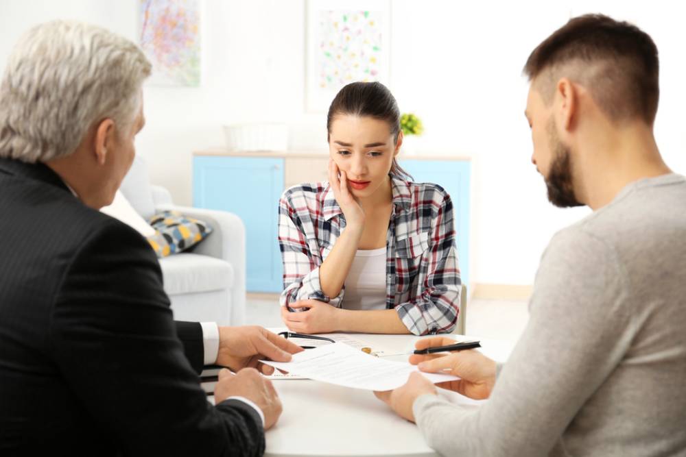 Young couple completing divorce at notary public office