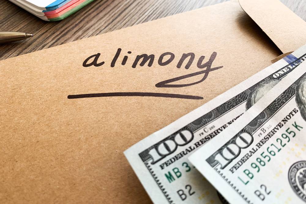 Payments alimony. White envelope with sign alimony and money